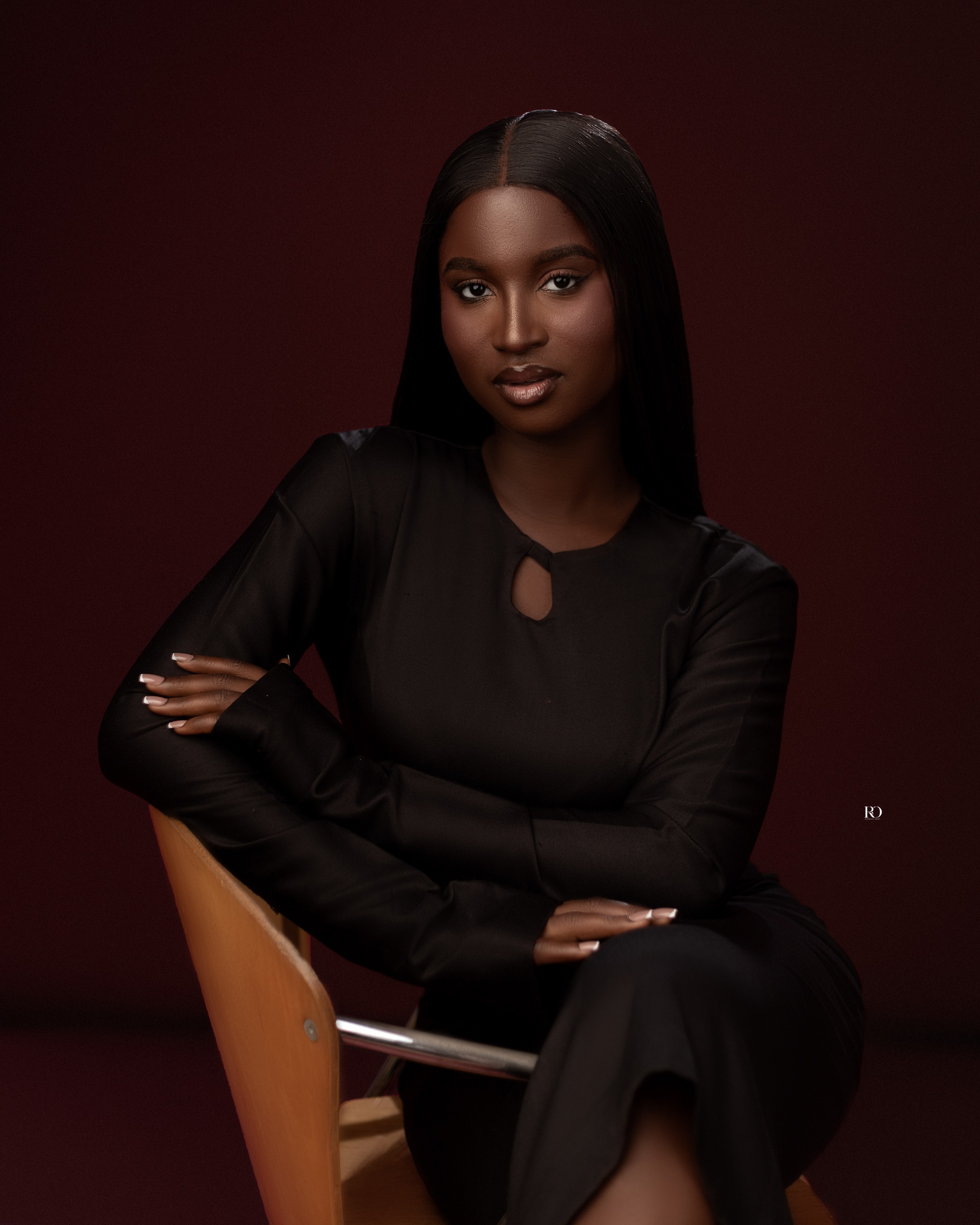 Gladys Ogo seated at a table, looking off to the side